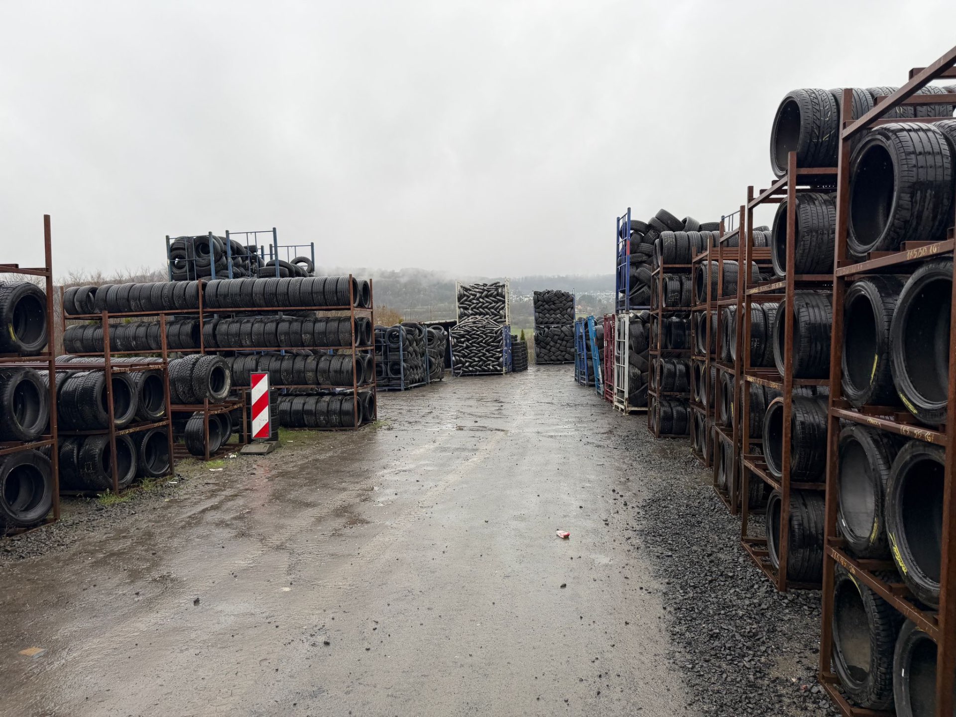 Wide view of the A2Z Tyre Recycling yard with racks of tyres