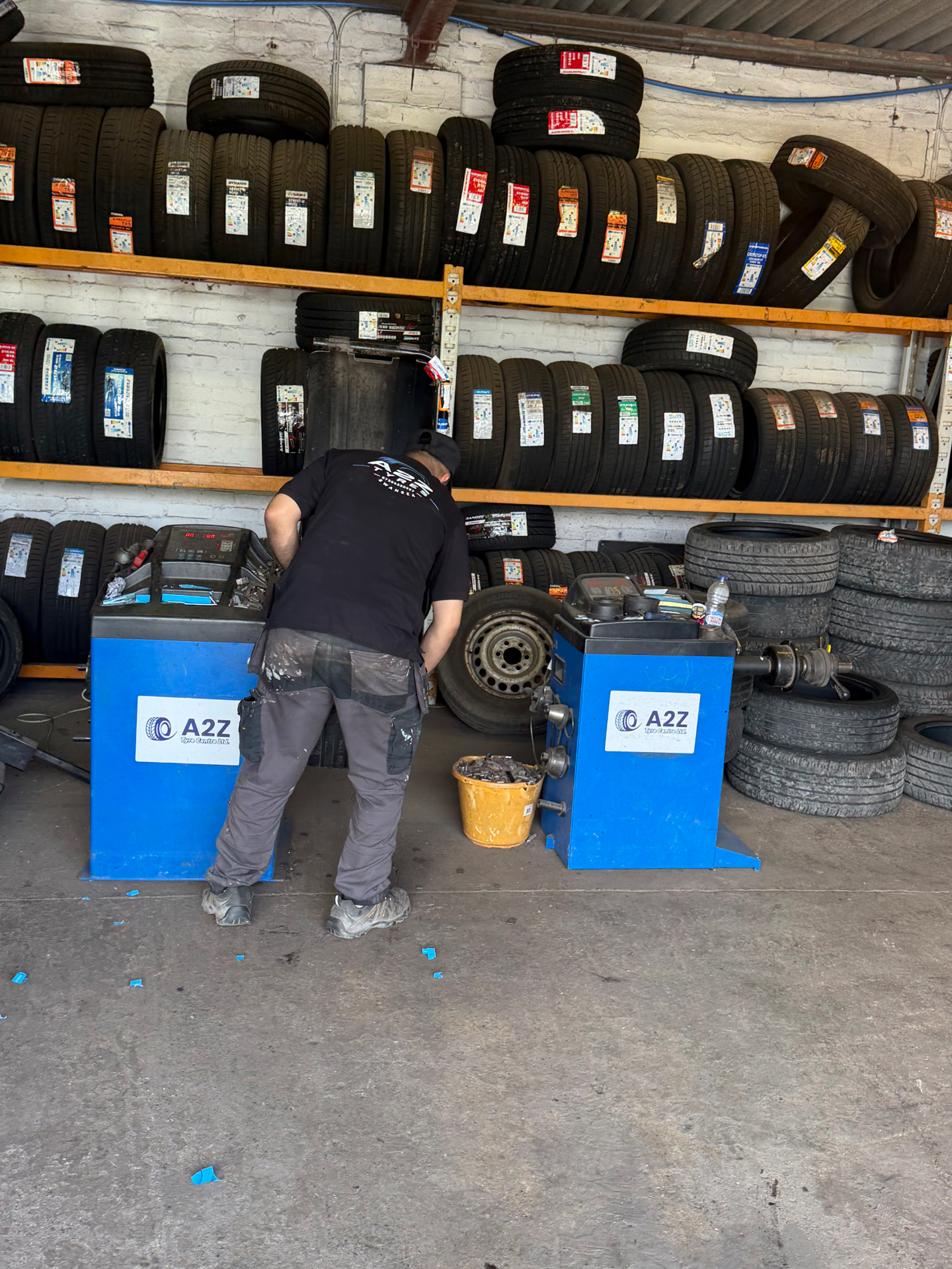 A2Z workshop with wheel balancing machines in front of racks of tyres