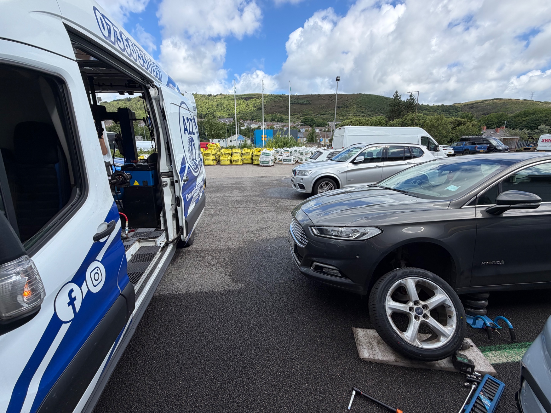 A2Z van fitting a tyre in a supermarket car park
